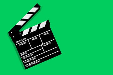 Fototapeta na wymiar Movie clapperboard for shooting videos and movies on a green background copy space