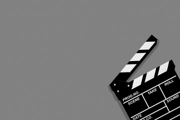 Movie clapperboard for shooting videos and movies on a grey background plenty of space for text