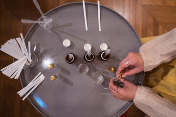 Crop master preparing perfume on table