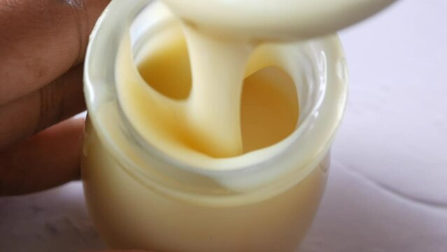 condensed milk in a bowl close up,