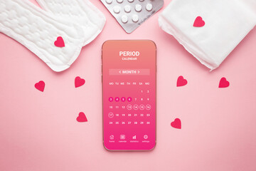 Menstrual cycle mobile app on smartphone screen on a pink background. top view
