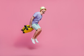 Full size photo of handsome young guy jump look empty space travel agency client dressed trendy...