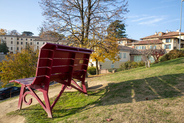Monforte d' Alba (CN), Italy - November 19, 2022: Monforte d' Alba village and giant bench, Cuneo, Piedmont, Italy.