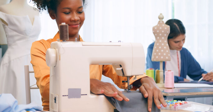 A group of young women are learning the profession of design and tailoring.
