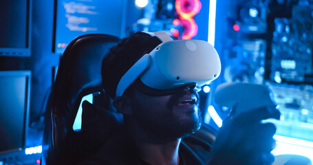 A hacker wearing virtual reality glasses is using computer to hack data to get ransom from victims.