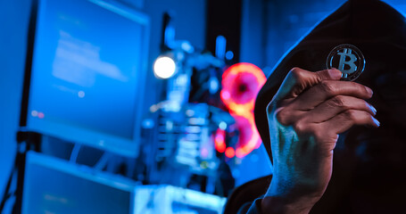 A male hacker is using a computer to hack data to demand ransom from victims.