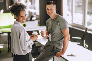 Two young colleagues taking a coffee break