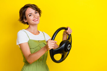 Photo portrait of adorable young lady holding car rudder toothy beaming smile wear trendy khaki...
