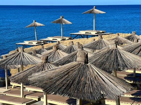 Beach umbrellas on the blue sea shore at summer.