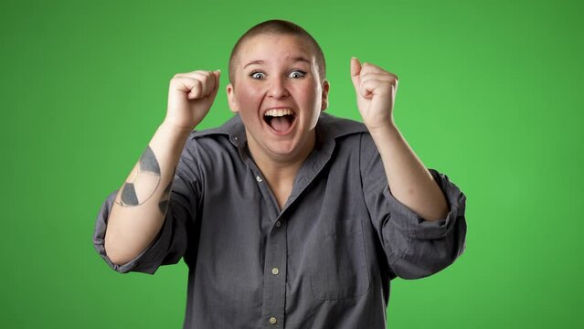 Young worried pleading non binary gender fluid woman 20s hold hands folded in prayer begging about something making wish keep fingers crossed isolated on green screen background studio.