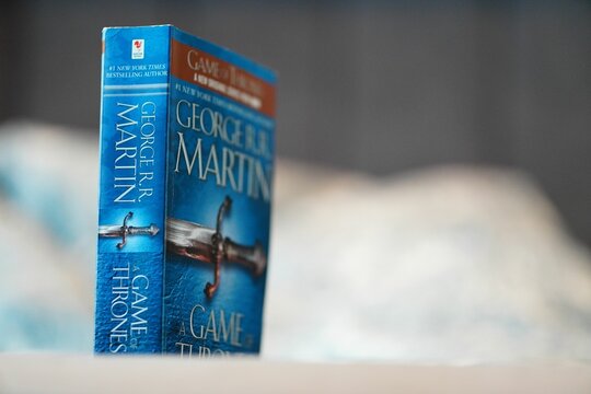 Close-up Of George R. R. Martin Game Of Thrones Fantasy Novel On A Blurred Background