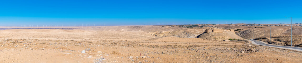 A panorama view towards the ruins of the crusader castle and surrounding countryside in Shobak, Jordan in summertime