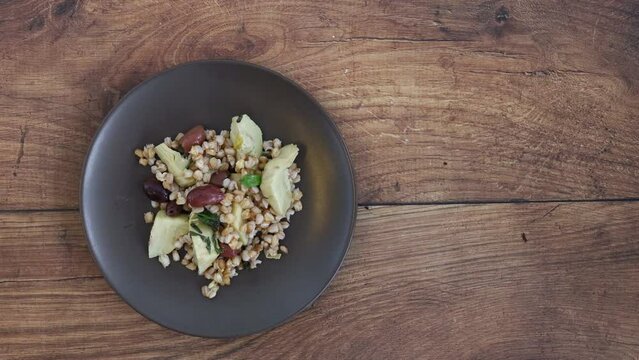 Serving a Farro Salad with Artichokes and Olives