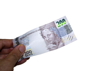 Hand holding a brazilian money two hundred real bill	Transparent background
