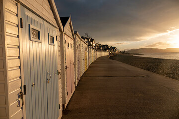 beach huts along the promenade at Lyme Regis Dorest England just after sunrise