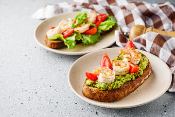 delicious Italian bruschetta with shrimps on a gray stone background