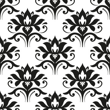 Floral vector ornament. Seamless abstract classic background with black and white flowers. Pattern with repeating floral elements. Ornament for wallpaper and packaging