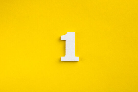Number one - white number in wood on yellow background