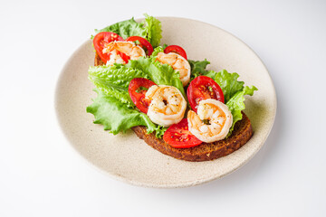 delicious Italian bruschetta with shrimps on a white background