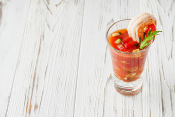 delicious summer gazpacho cocktail on a white wooden rustic background