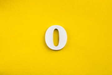 Fototapeta na wymiar Number 0 - White wooden number on yellow background