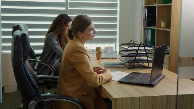 New employee asks about corporate app program software receiving helpful information from trainer colleague. Apprenticeship concept