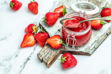 Jar of strawberry jam on white background. Homemade strawberry marmelade and fruits. Long banner format
