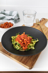 Homemade zucchini spaghetti with vegan bolognese sauce made with textured soy