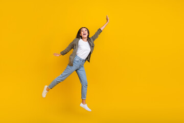 Fototapeta na wymiar Full body size photo of young crazy japanese addicted shopaholic lady jumping air raise arm up empty space isolated on yellow color background