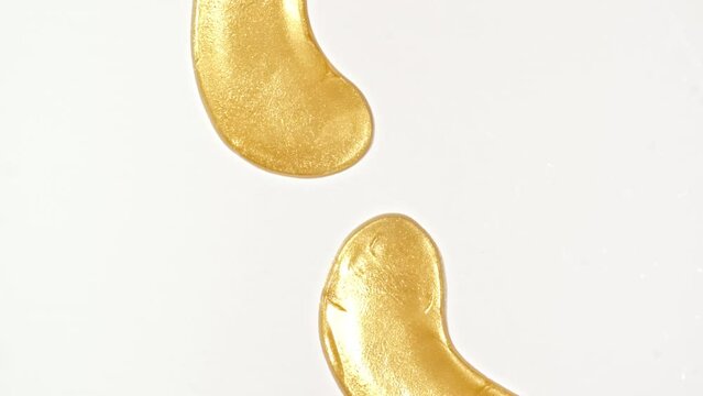 Golden patches for the eyes and facial mask for skin care Isolated on white background. Women's cosmetics skincare. Sample of packaging for design, beauty product, advertising.4k. High quality 4k 
