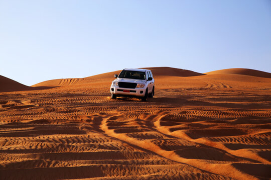 Off road vehicle on sand dunes, Oman