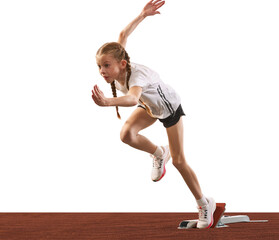 Young athlete, beginner female track runner bursting off starting block isolated over white...