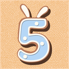 Christmas gingerbread in the shape of the namber with rabbit ears, white blue glaze, polka dots