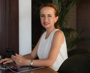 Closeup of beautiful woman sitting with magazine
