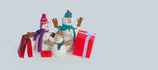 Snowman with Christmas gift. Merry Christmas and happy new year greeting card with copy space. Snowman banner.