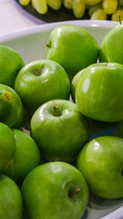 Fresh raw fruits, apples on a modern white kitchen table. Healthy eating. Organic food.