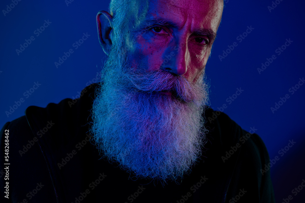 Poster Photo of suspicious cool retired man dressed black pullover looking you xmas thief isolated dark blue color background