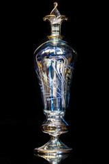 Botella de cristal antiguo en tonos azules sobre fondo oscuro