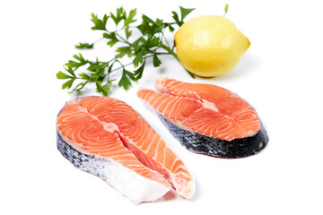 Salmon, slice of fresh raw fish with parsley and lemon, isolated on white background