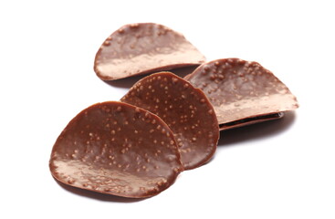 Pile of cripsy dark chocolate wave chips isolated on white