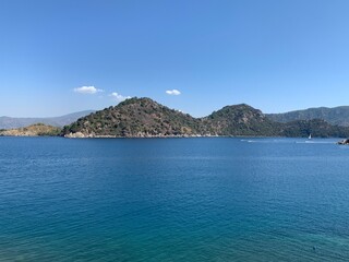 Fototapeta premium View rocks. Summer landscape, sea and mountain. Sea view. Landscapes of Turkey city Marmaris. View of a paradise sea, clear water.