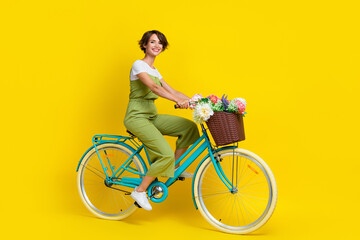 Full body photo of gorgeous young lady riding bicycle feminine movement wear trendy khaki clothes...