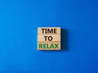 Time to relax symbol. Concept word Time to relax on wooden blocks. Beautiful blue background. Business and Time to relax concept. Copy space