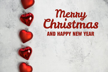 Merry christmas and happy new year text on background with heart shaped ornaments