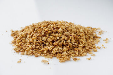 fresh raw buckwheat flakes on a white background