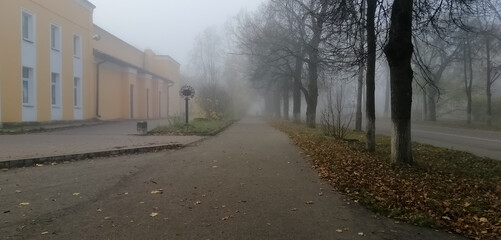 Fog in the city. The figure of a man in the distance disappearing into the fog