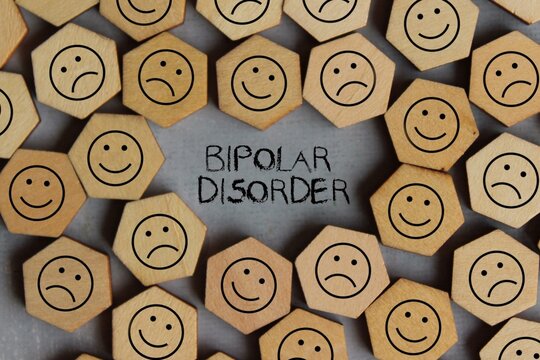 Top view image of smile and sad icon with text BIPOLAR DISORDER. Medical and healthcare concept