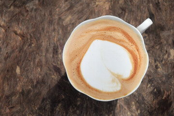 Cappuccino with frothy foam, vintage white cup coffee on wood background. Flat lay style