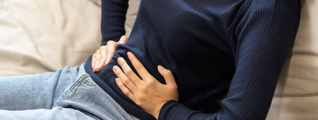 Flatulence asian young woman, girl hand in stomach ache, suffer from food poisoning, abdominal pain...
