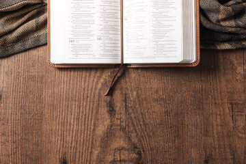 An open Bible on a wooden table, copyspace, flat lay bible